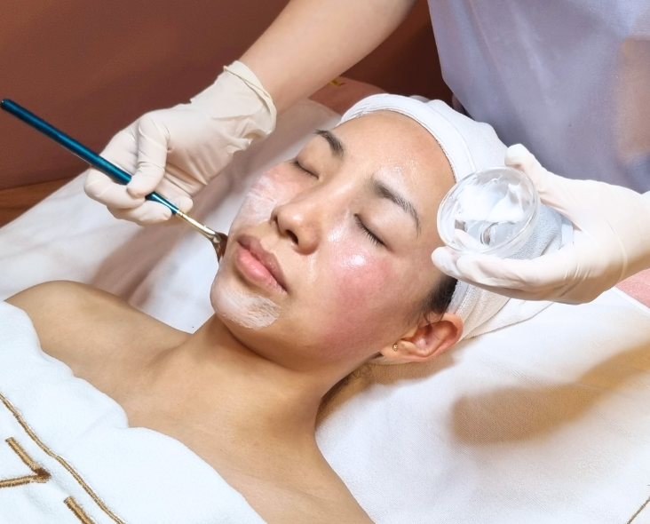 Woman undergoing chemical peel treatment.